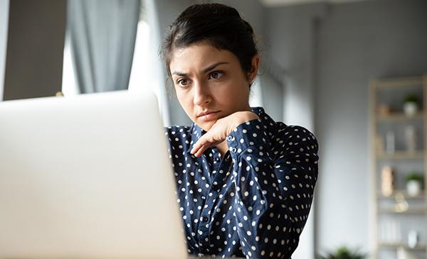 woman staring at her laptop